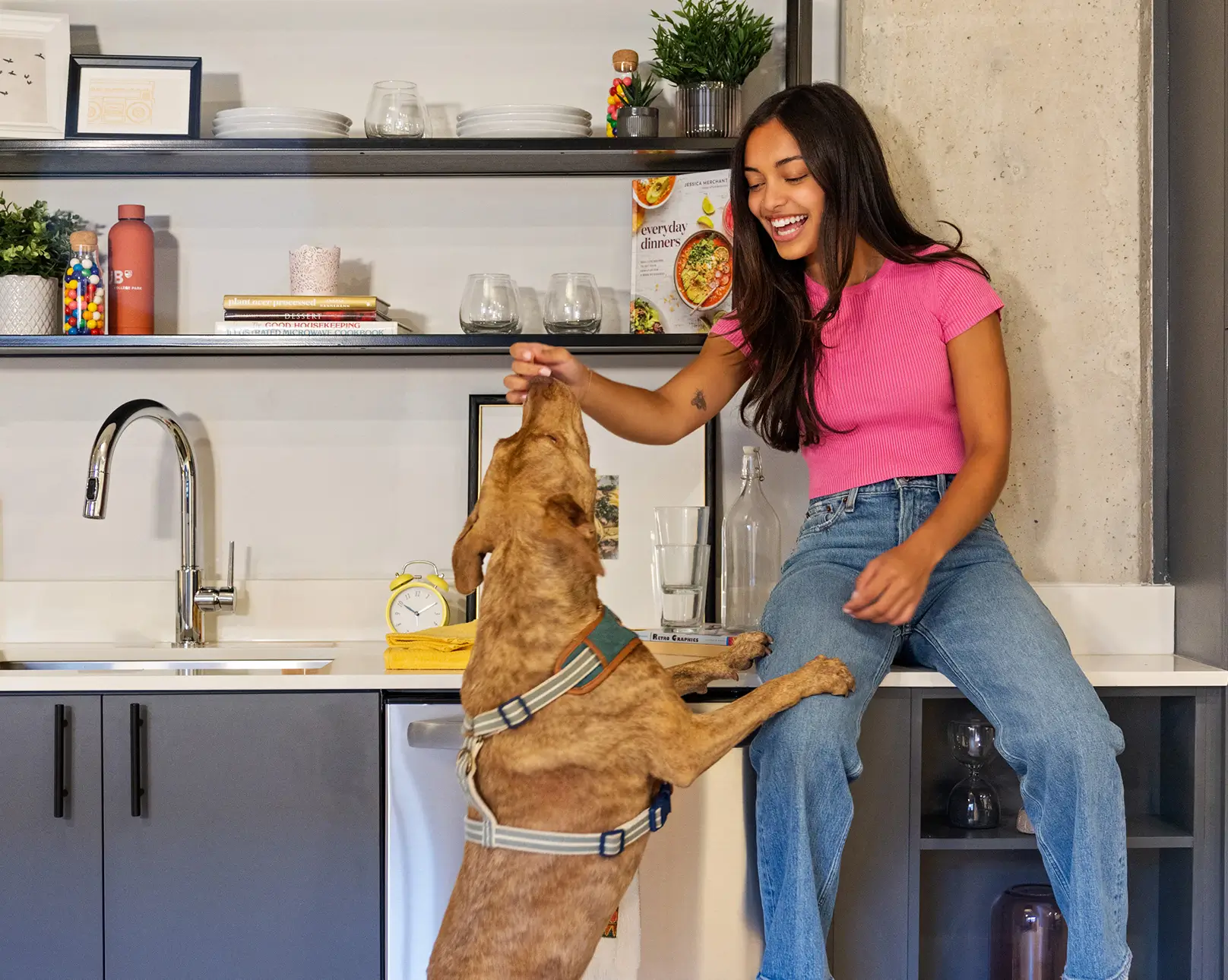 young woman playing with a dog