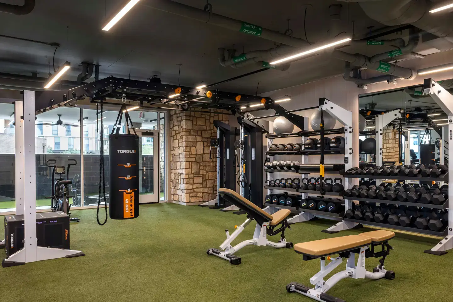 Student apartment gym with a variety of equipment